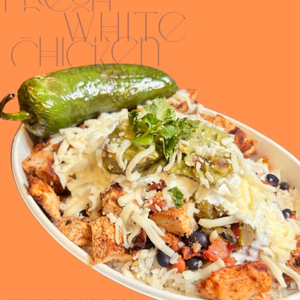 Taza Modern Mexican chicken bowl with rice, beans, cheese, guacamole, and a green chili.